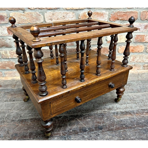 1436 - Victorian walnut four divisional Canterbury, fitted with a single drawer on four ceramic casters, 55... 