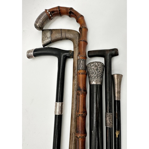 472 - Four ebonised silver applied walking canes to include a Sunday stick with further Sunday stick and b... 