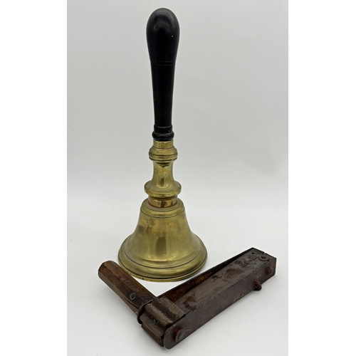 1189 - Large ebonised handle brass hand or school bell, 42cm long with further treen crow scarer or footbal... 