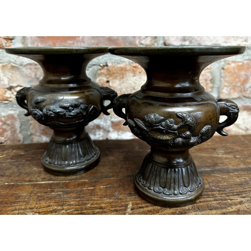 1082 - Pair of Japanese bronze twin handles vases, in relief with mythical beasts and elephant head handles... 