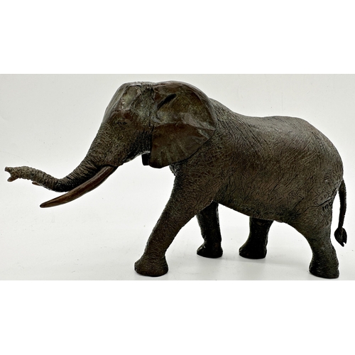 428 - Good quality cast bronze study of a standing elephant, 28cm long