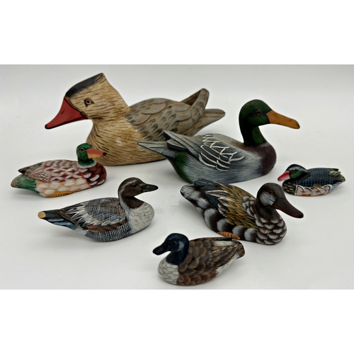 1161 - Seven carved and painted decoy ducks, the largest 27cm long