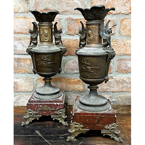 1201 - Pair of French cast mental twin handled garniture vases, repoussé decoration of Roman soldier on hor... 