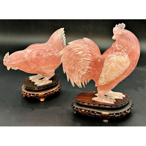 1044 - Pair of Chinese pink jade Cockerel and hen, bespoke stands, the cock 17cm high