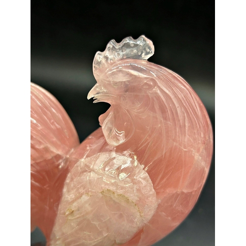 1044 - Pair of Chinese pink jade Cockerel and hen, bespoke stands, the cock 17cm high