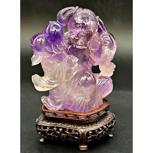 1046 - Chinese amethyst jade of a lady holding radishes, bespoke stand, 11cm high