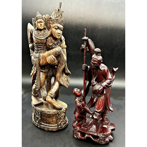 1053 - Eastern hardwood of two theatrical figures, 32cm high with Japanese carving of fisherman and boy (2)