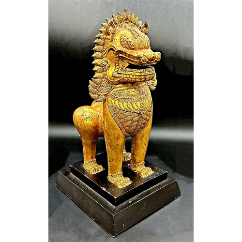 1056 - Good quality gilt bronze temple dog or lion on a bespoke base, 36cm high