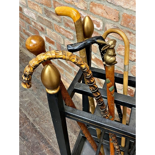 461 - Ebonised six divisional stick stand with gilt finials, fitted with nine walking sticks to include a ... 