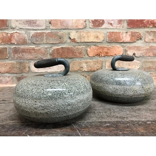 1111 - Good pair of polished granite curling stones with inset wooden handles, 28cm diameter