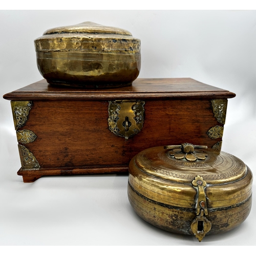 1061 - Indian teak and brass bound twin handled box, the hinged lid enclosing two candle boxes, 49cm long w... 