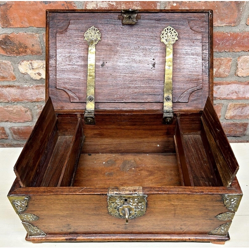 1061 - Indian teak and brass bound twin handled box, the hinged lid enclosing two candle boxes, 49cm long w... 