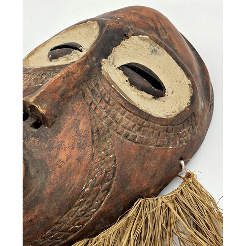 1042 - African tribal mask with clay eyes and straw beard, 53 x 43cm