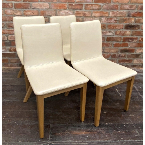 1296 - Set of four modernist cream leather dining chairs with stylised x-frames