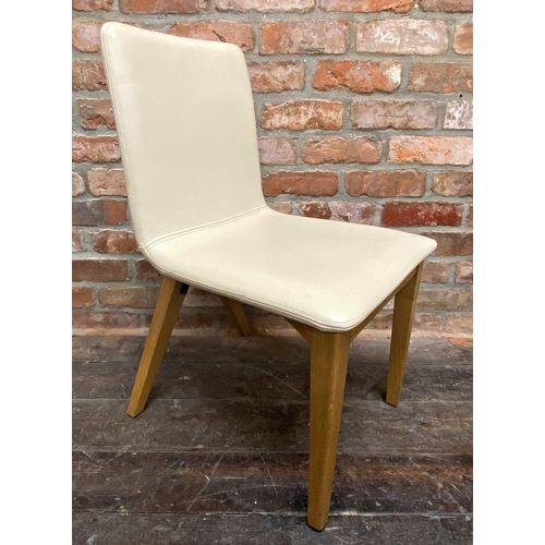 1296 - Set of four modernist cream leather dining chairs with stylised x-frames