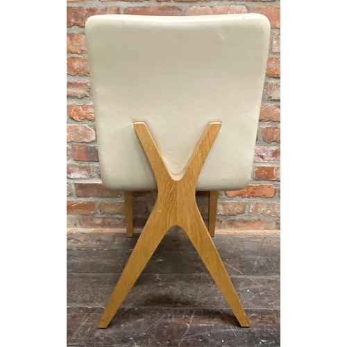 1296 - Set of four modernist cream leather dining chairs with stylised x-frames