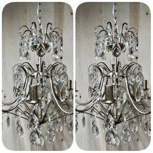 1211 - A contemporary pair of silvered metal crystal drop chandeliers with various glass prismatic drops, 5... 