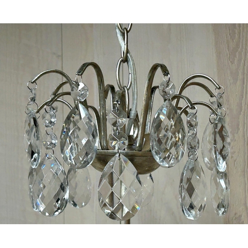 1211 - A contemporary pair of silvered metal crystal drop chandeliers with various glass prismatic drops, 5... 