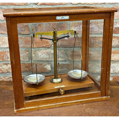 1108 - Teak glazed case of precision scales by De Grave Short & Co Ltd of London, 45cm wide