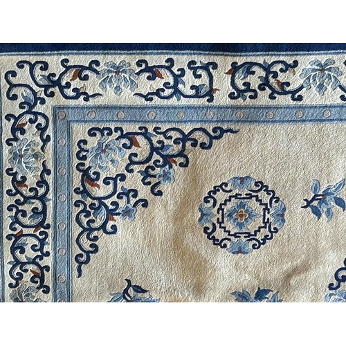 1255 - Chinese wool carpet with geometric medallions on a cream ground, 290 x 185cm