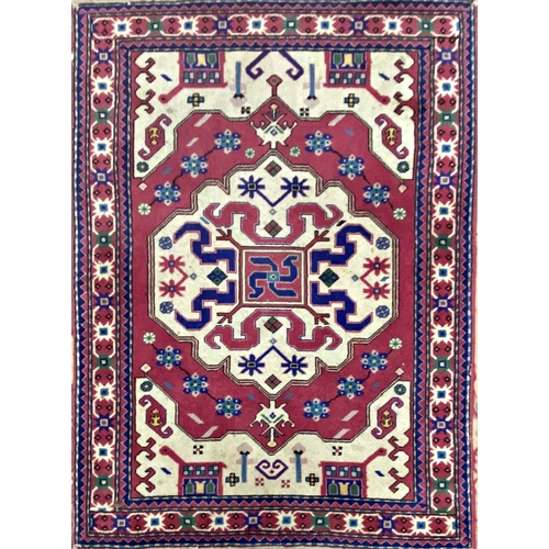 1252 - Unusual persion silk blend rug, with medallions and architecture on a pink ground, 150 x 110cm