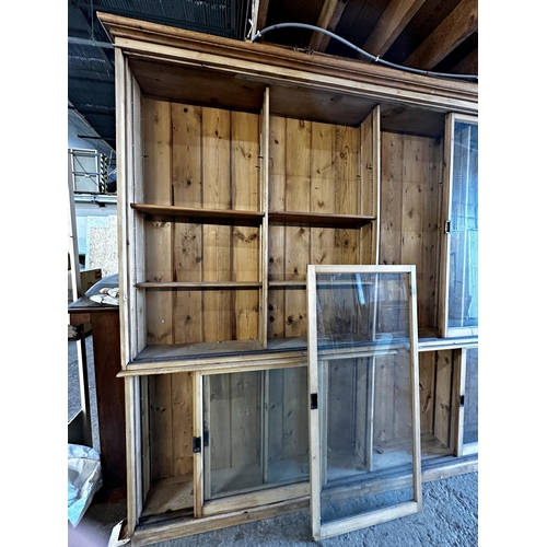 1489 - Good large 19th century pine shop display cabinet, with sliding glazed doors enclosing a shelved int... 