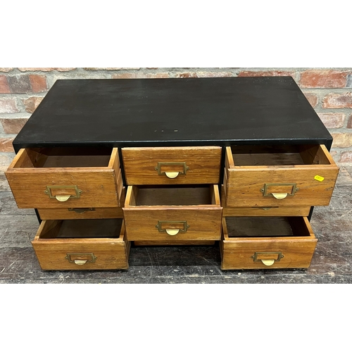 1183 - Vintage Industrial table top bank of nine drawers, with brass fittings in an ebonised case, 43cm hig... 