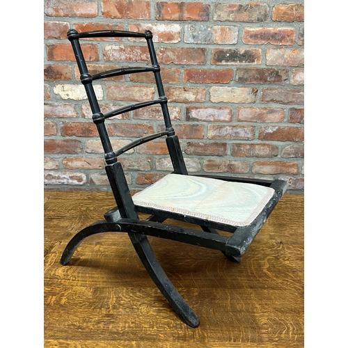 1192 - Probably by E W Godwin, ebonised folding chair, with gilt highlights, 70cm high