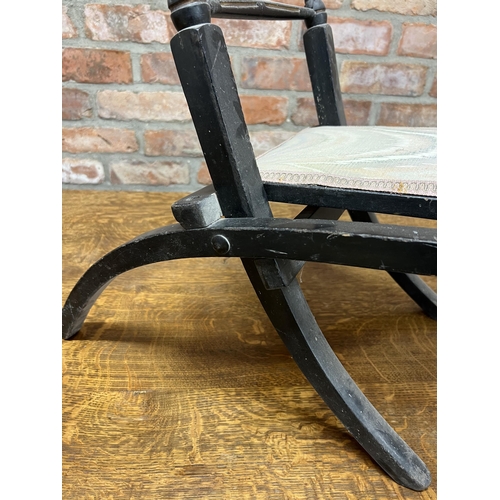 1192 - Probably by E W Godwin, ebonised folding chair, with gilt highlights, 70cm high