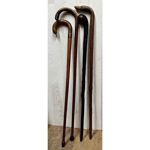 162 - Four walking sticks - swordstick, horn handled crook, dog head and silver knop (4)