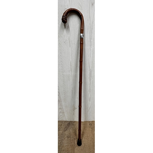 173 - A late 19th/early 20th century bamboo silver collared walking stick, the crook with knobbled end, ma... 