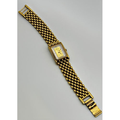 351 - A ladies Brooks & Bentley wristwatch, the dial with inset gold 1g 999.9 ingot, on yellow metal strap... 