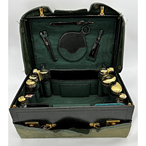 309 - Exceptional quality Edwardian racing green leather vanity case, with canvas protector, enclosing eig... 