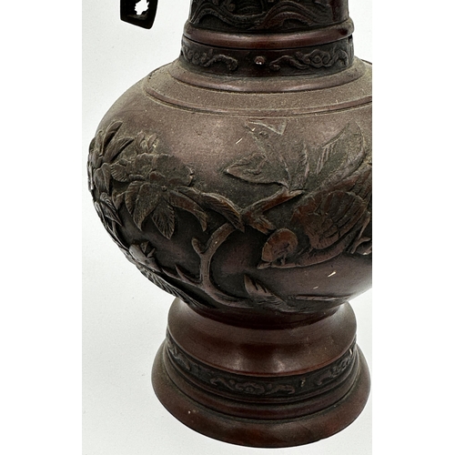 509 - Japanese Meiji period bronze twin handled vase, with relief decoration of birds amidst foliage, 25.5... 