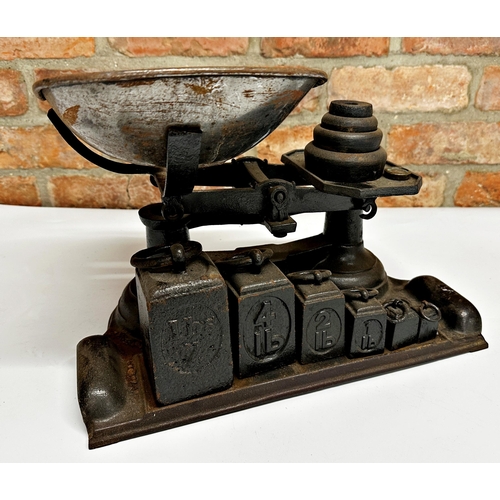 599 - Vintage cast iron counter scales with two sets of graduated weights, 40cm long