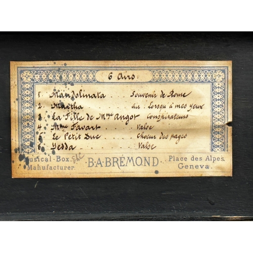 378 - Good quality small exotic wood cased music box by B A Bremond, playing six airs, 16cm long, with key