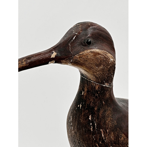 536 - Guy Taplin (b. 1939) - Curlew, signed to base, painted wooden carving on stand, 43cm high x 65cm lon... 