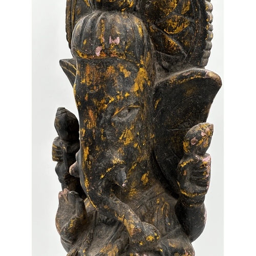 512 - Antique carved wooden study of Ganesh, with traces of original paint, 63cm high