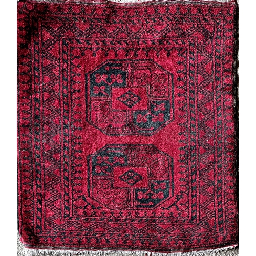 1407 - Full pile Bokhara rug, two black medallions on a red ground, 120 x 105cm