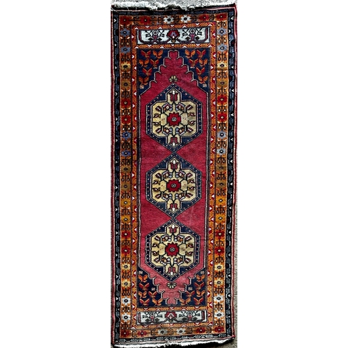 1409 - Good full pile Afghan runner with red motifs on a blue ground, 290 x 110cm