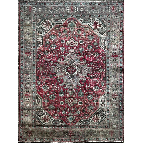 1410 - Heriz carpet, with medallion and scrolled decoration on a red ground, 310 x 200cm