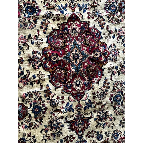 1411 - Large full pile country house Tabriz carpet, red a blue medallions on a cream ground, 350 x 245cm