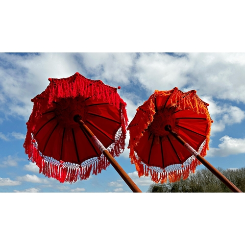 1050 - Pair of Eastern colourful long parasols,
Height 254cm x 83cm Diameter (Open)