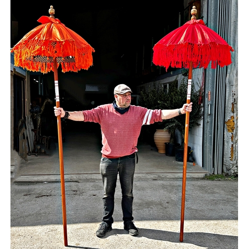 1050 - Pair of Eastern colourful long parasols,
Height 254cm x 83cm Diameter (Open)