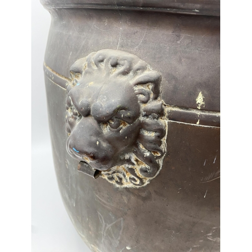 604 - Very large antique copper log bucket, embossed with a family scene, twin lion head handles, 50cm hig... 