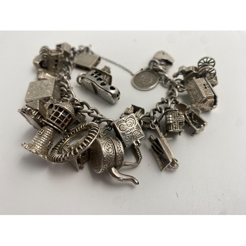 317 - Good silver charm bracelet with a good collection of mainly hinged silver charms, 116g approx