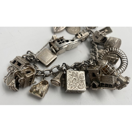 317 - Good silver charm bracelet with a good collection of mainly hinged silver charms, 116g approx