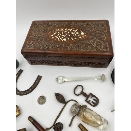 417 - Box of interesting items to include three turned pipes, pocket watch stand, carved betel nut, bell g... 