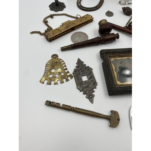 417 - Box of interesting items to include three turned pipes, pocket watch stand, carved betel nut, bell g... 