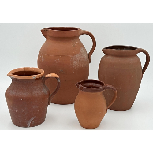 357 - Harlequin set of four graduated terracotta jugs, the largest 28cm high